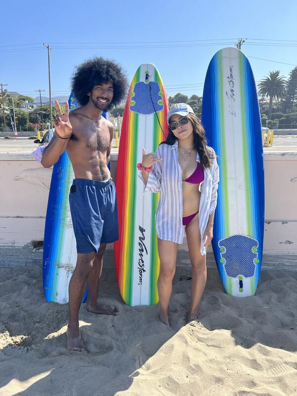 Counselors Kiana and Chris Surfing at Aloha Beach Camp